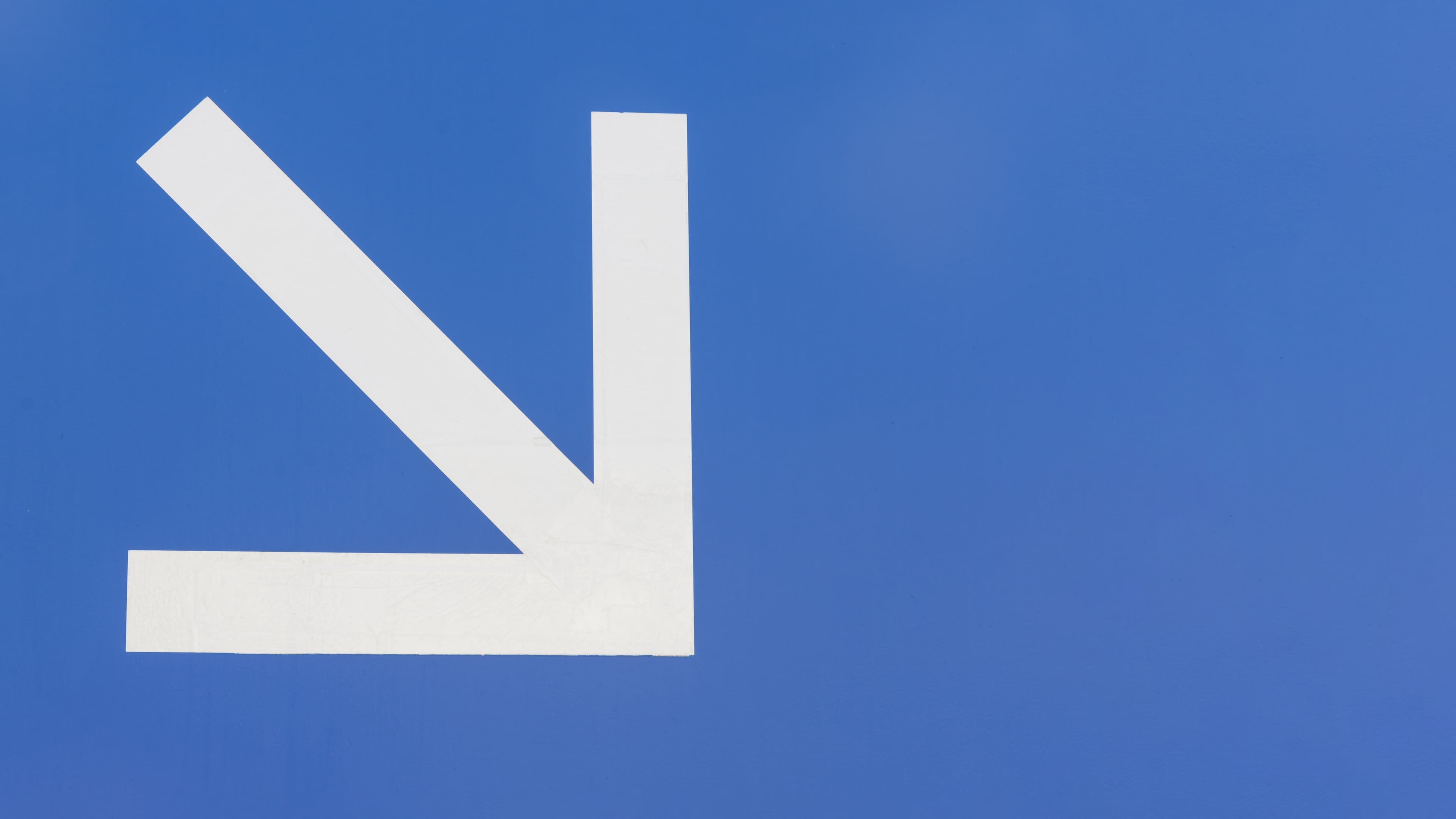 minimalist-white-downstairs-arrow-blue-background