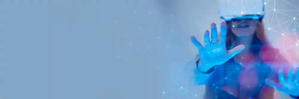 Woman wearing VR headset representing immersive design and technology solutions Woman wearing VR headset representing immersive design and technology solutions